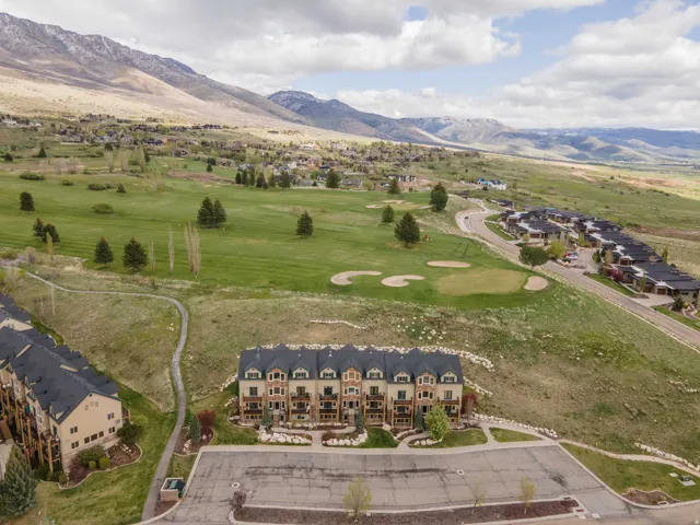 Bird's eye view of a mountainous background and a local golf course