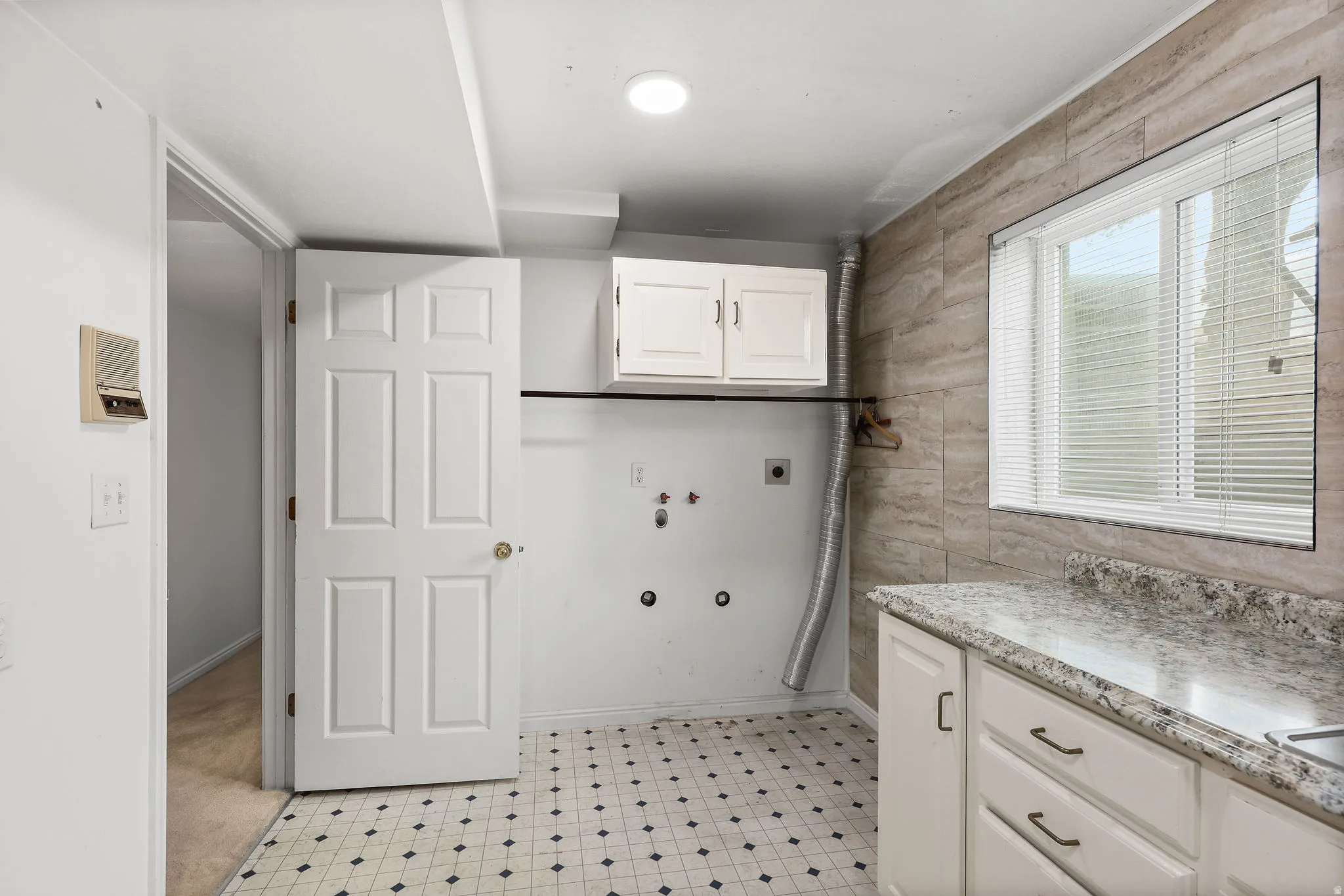 Laundry room featuring cabinet space, hookup for a gas dryer, hookup for an electric dryer, washer hookup, and light flooring
