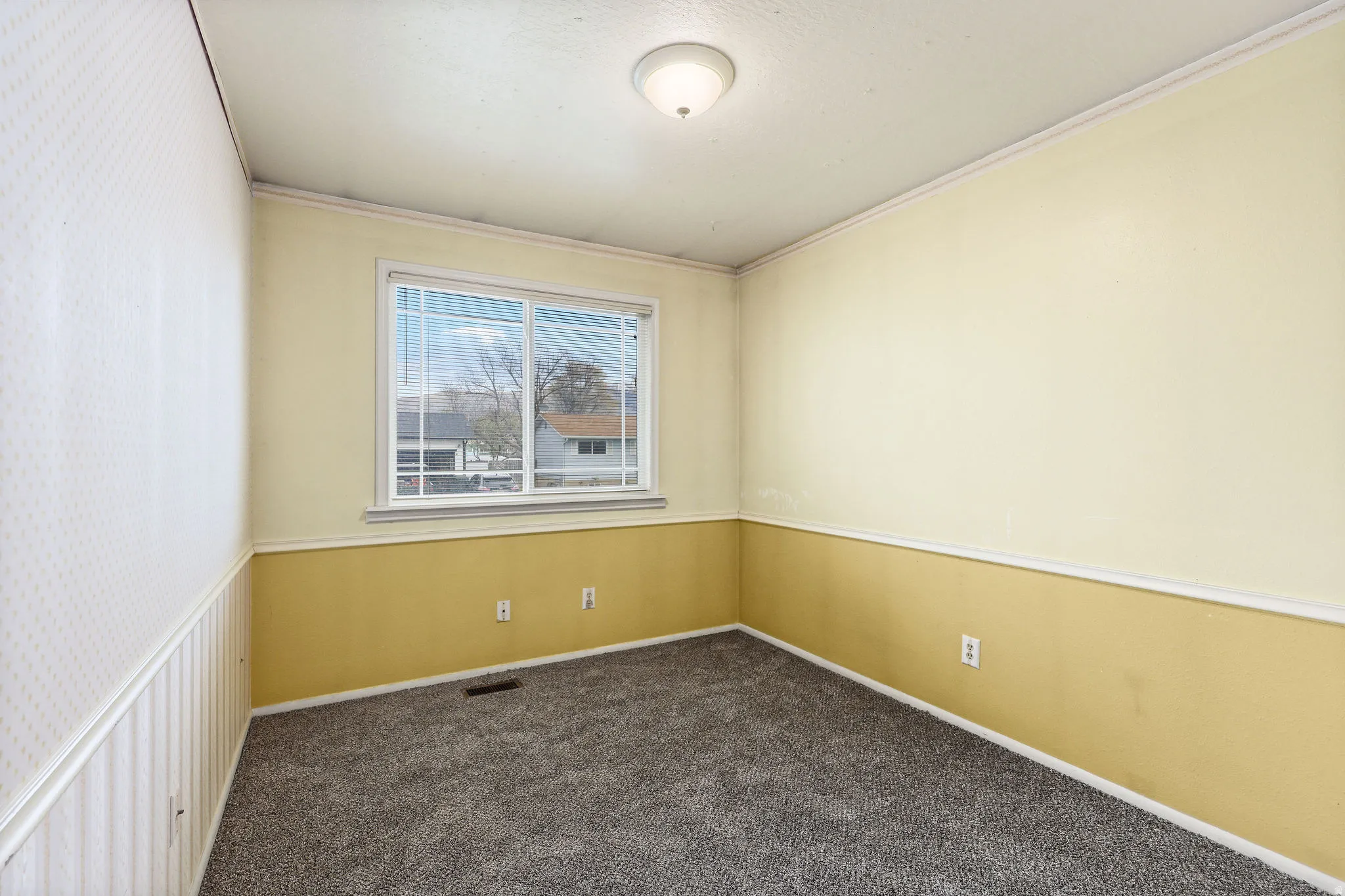 Empty room with dark carpet and crown molding