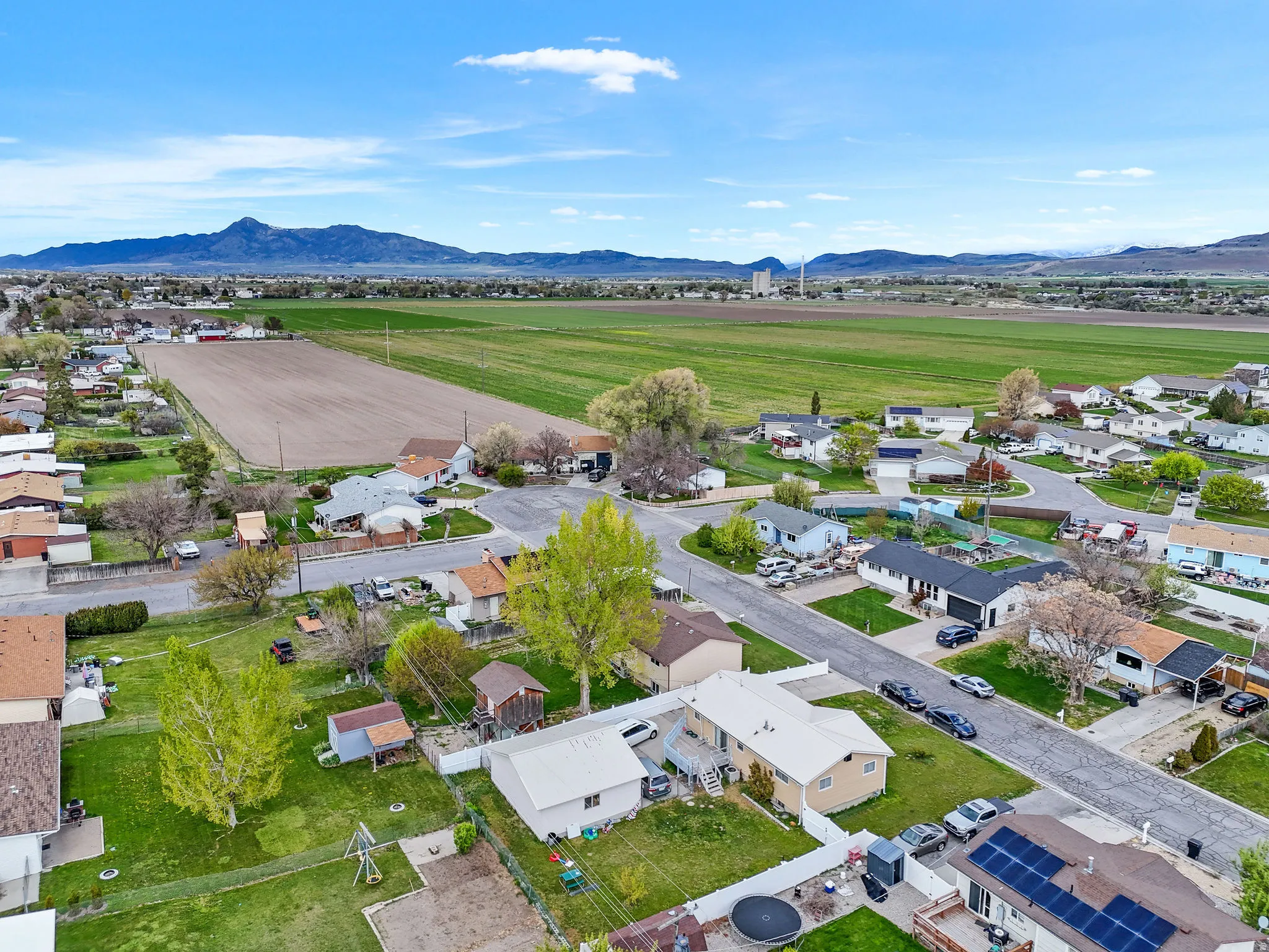 View of rural area with nearby suburban area and mountains