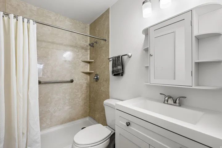 Bathroom featuring vanity and a stall shower