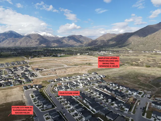 Aerial view of property and surrounding area with nearby suburban area and mountains