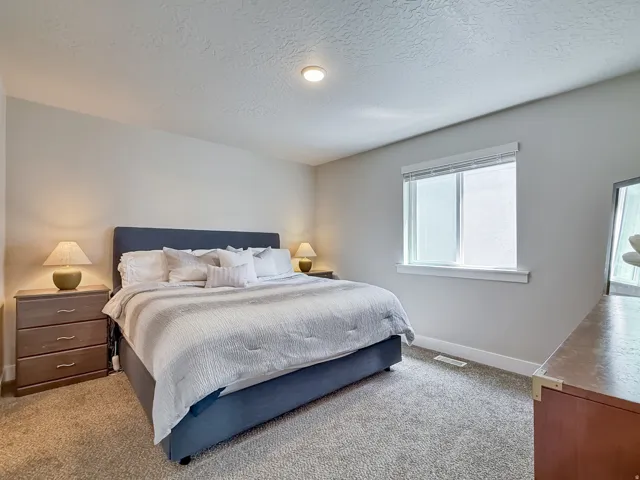 Bedroom featuring a textured ceiling and carpet flooring