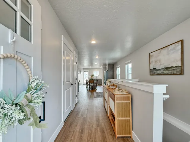 Corridor featuring wood finished floors, a textured ceiling, and recessed lighting