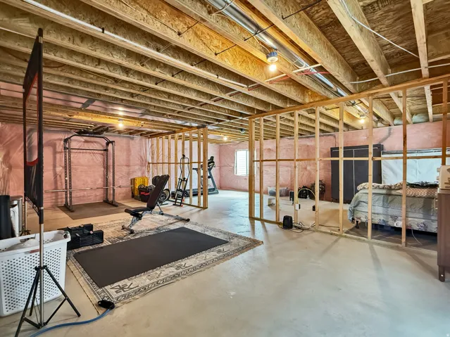 Exercise area featuring finished concrete floors