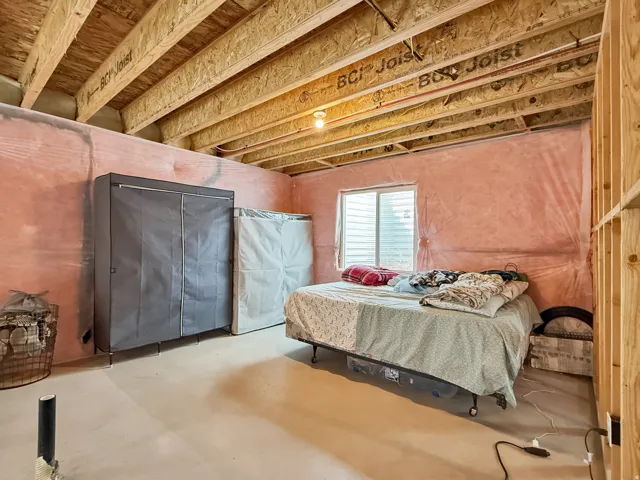 Bedroom featuring finished concrete flooring