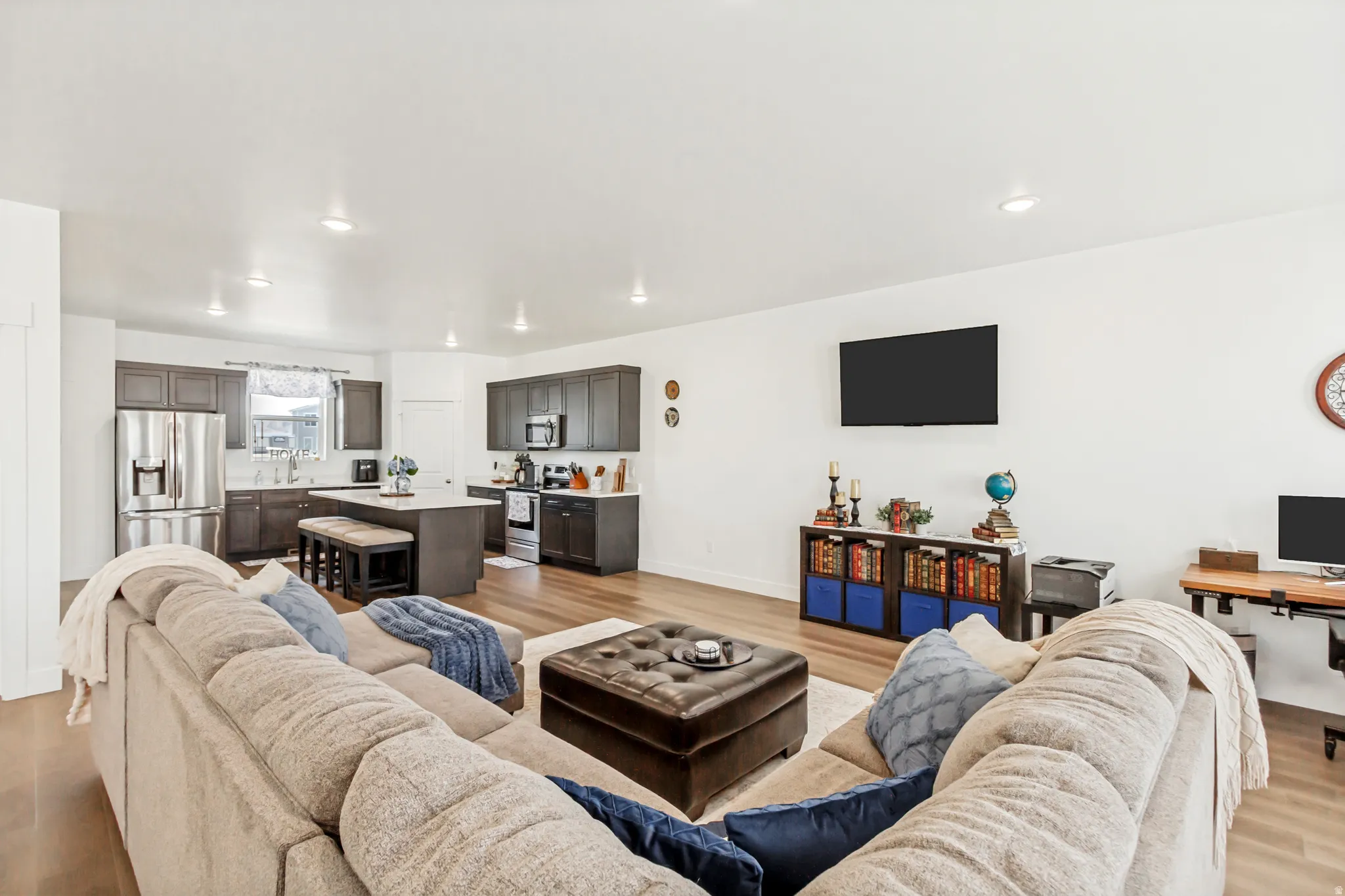 Family room with light wood-style flooring and recessed lighting