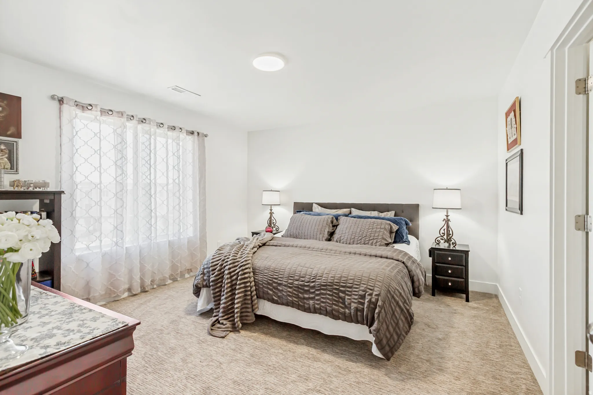 Owners suite featuring light carpet and a beautiful window.