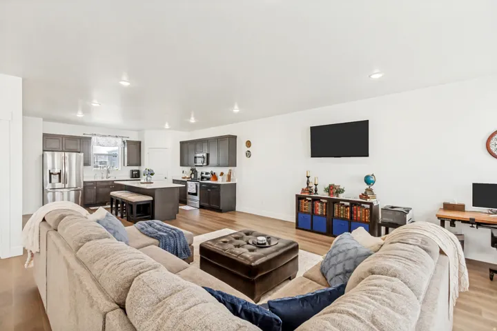 Family room with light wood-style flooring and recessed lighting