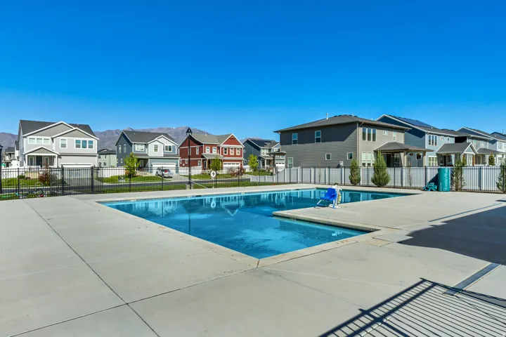 Community pool featuring a residential view and a patio.