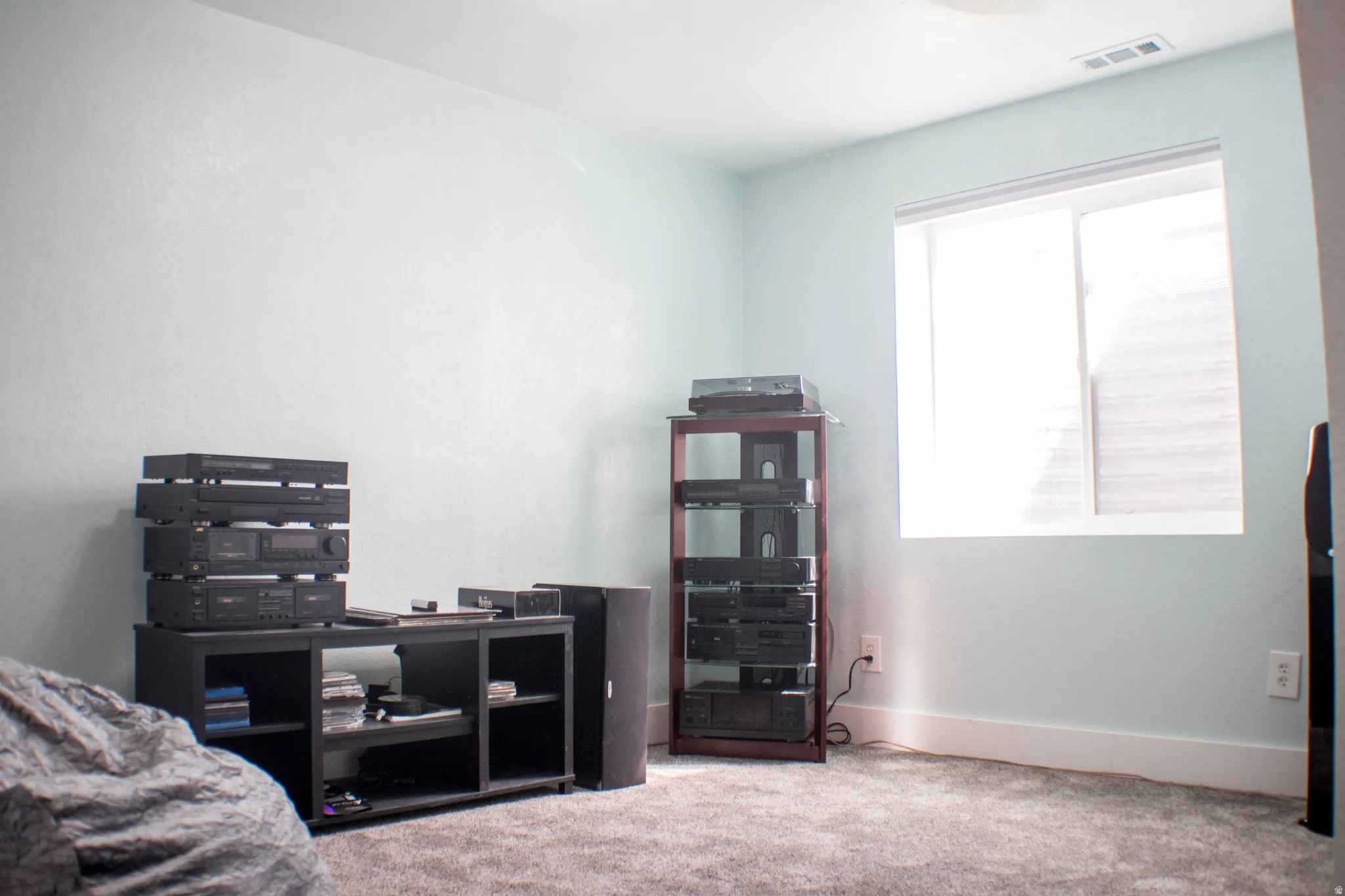 Bedroom with light colored carpet and baseboards