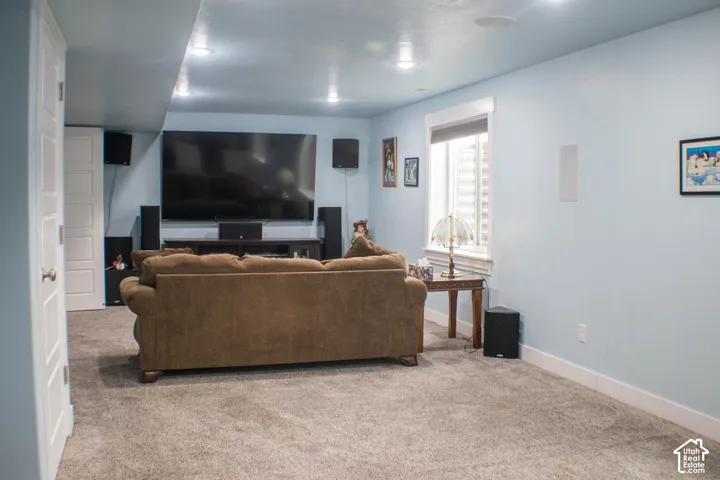 Carpeted room featuring recessed lighting and a large window with white trim