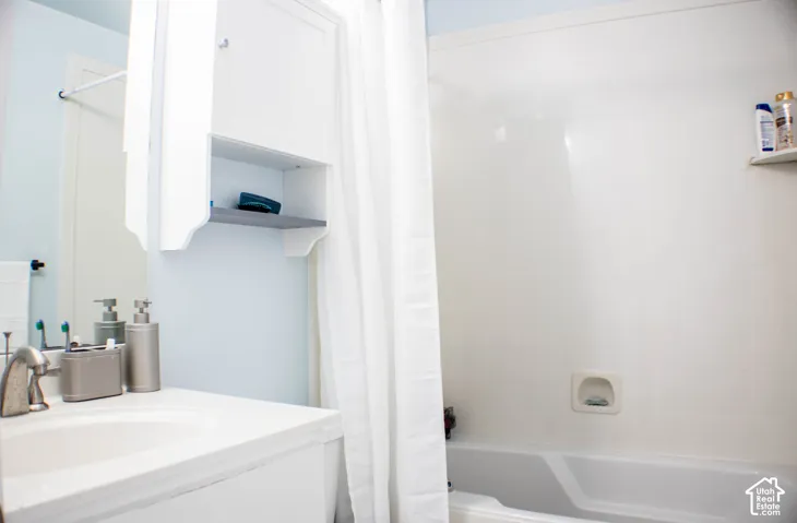 White built-in bathtub with integrated wall shelving