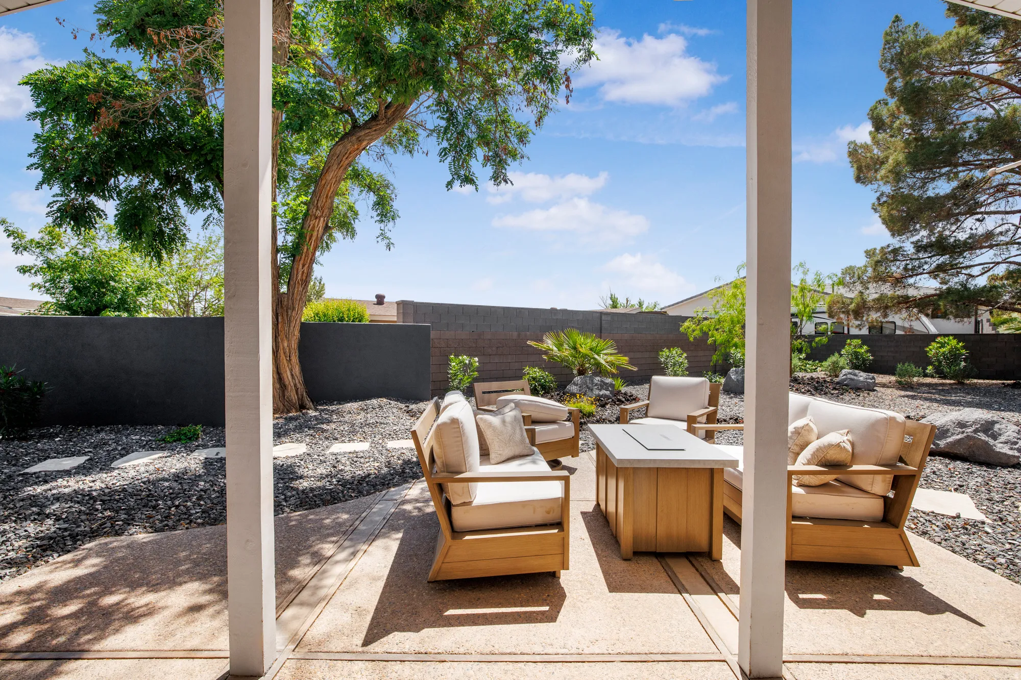 Fenced backyard featuring a patio and an outdoor living space with a fire pit
