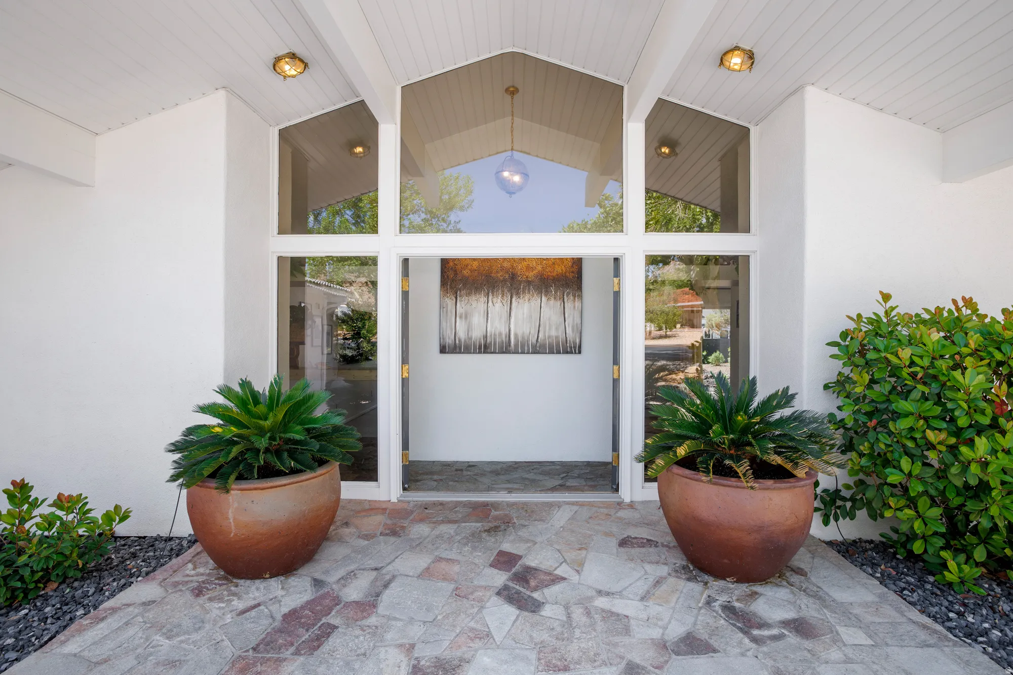 Property entrance with stucco siding and a patio