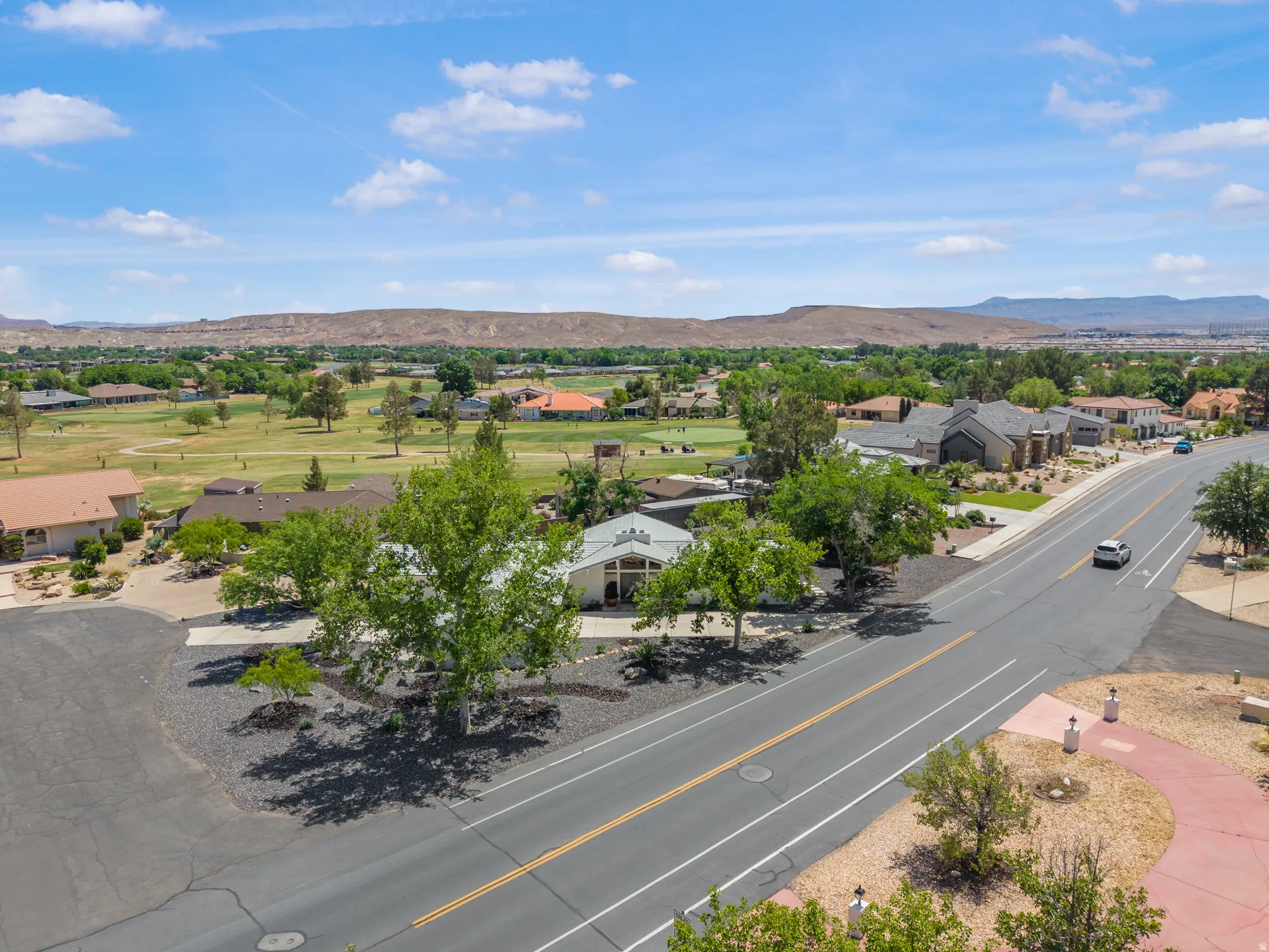 Aerial perspective of suburban area featuring a mountain backdrop