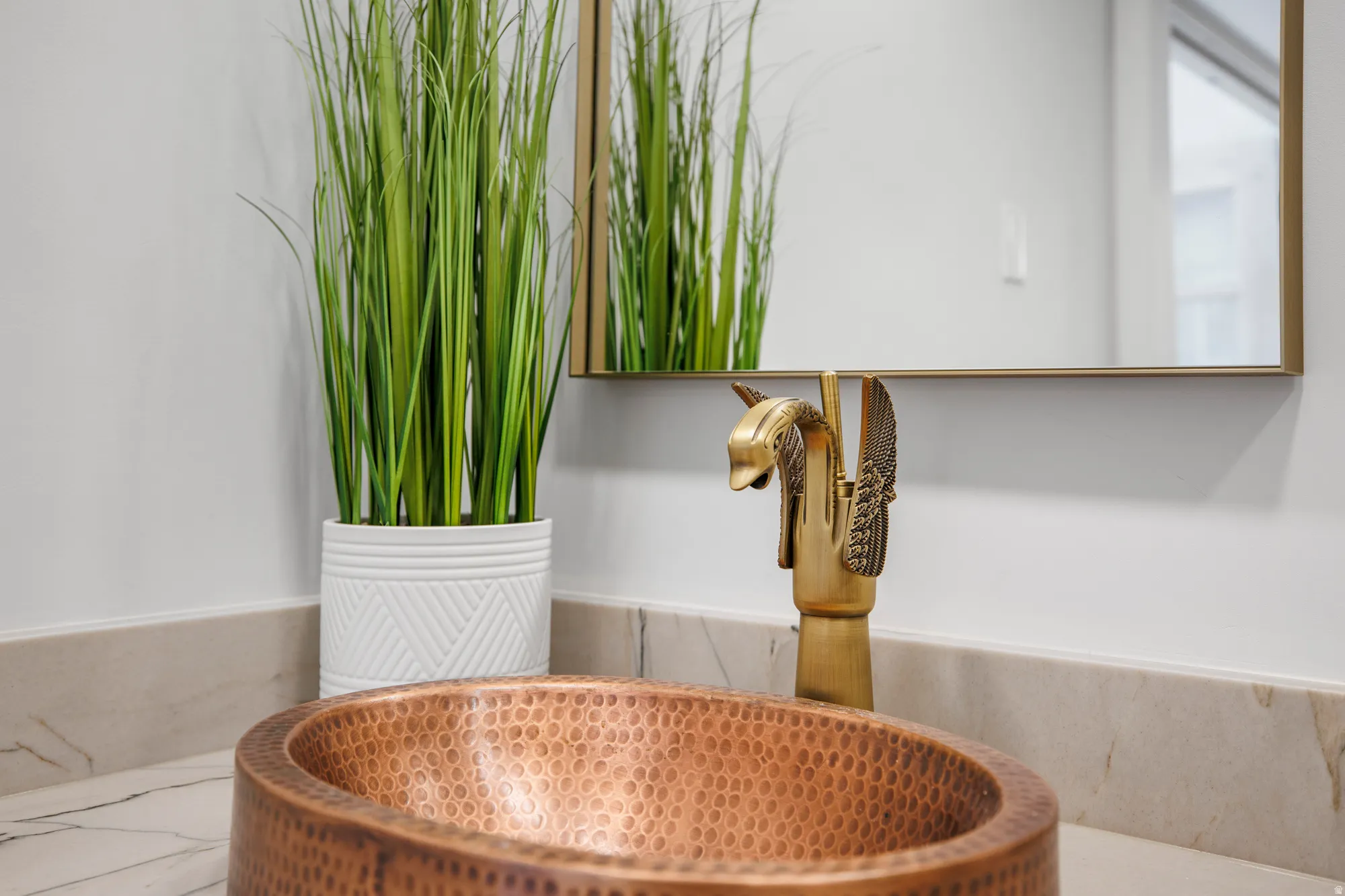 Bathroom view of a sink and a wainscoted wall