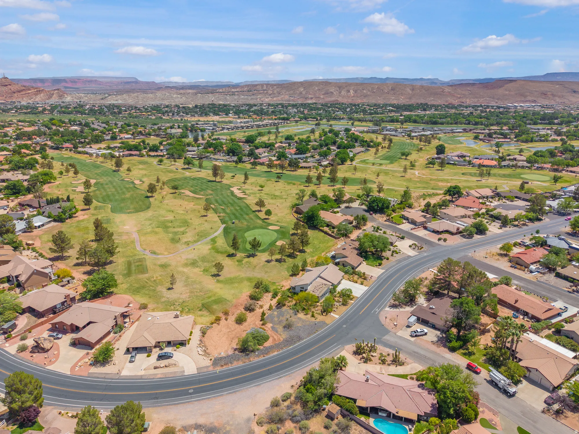 Aerial overview of property's location with mountains and nearby suburban area