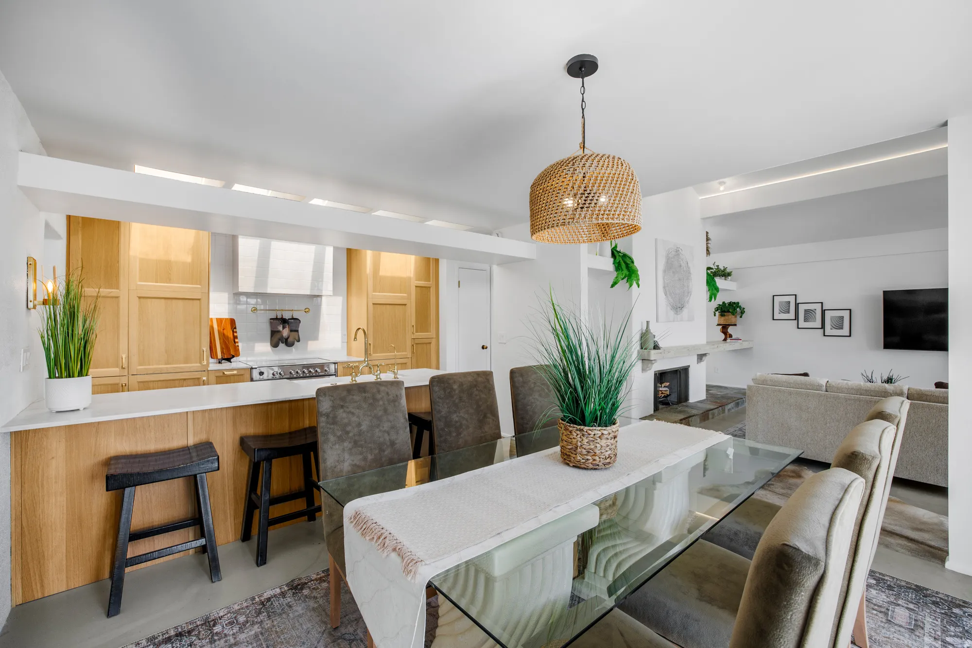 Dining space with concrete flooring and a fireplace with raised hearth