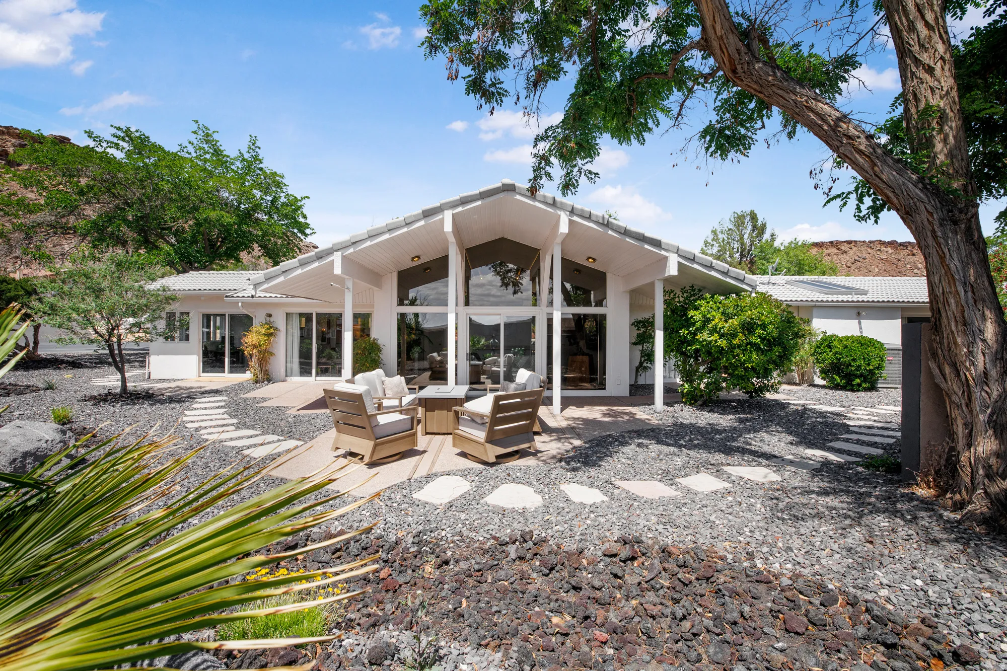 Rear view of house with a patio, an outdoor living space, and a tile roof