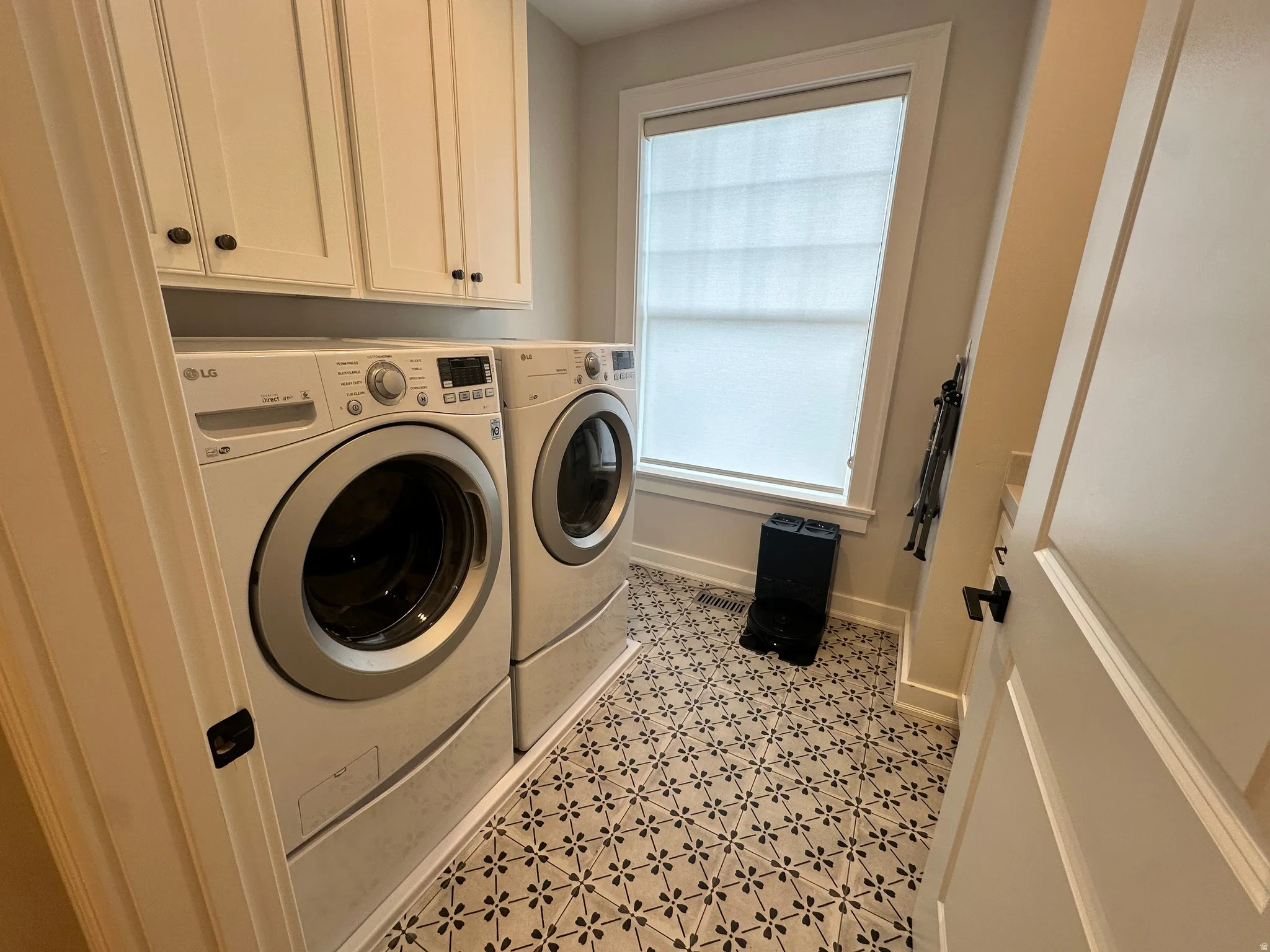 Laundry area with cabinet space and washing machine and dryer