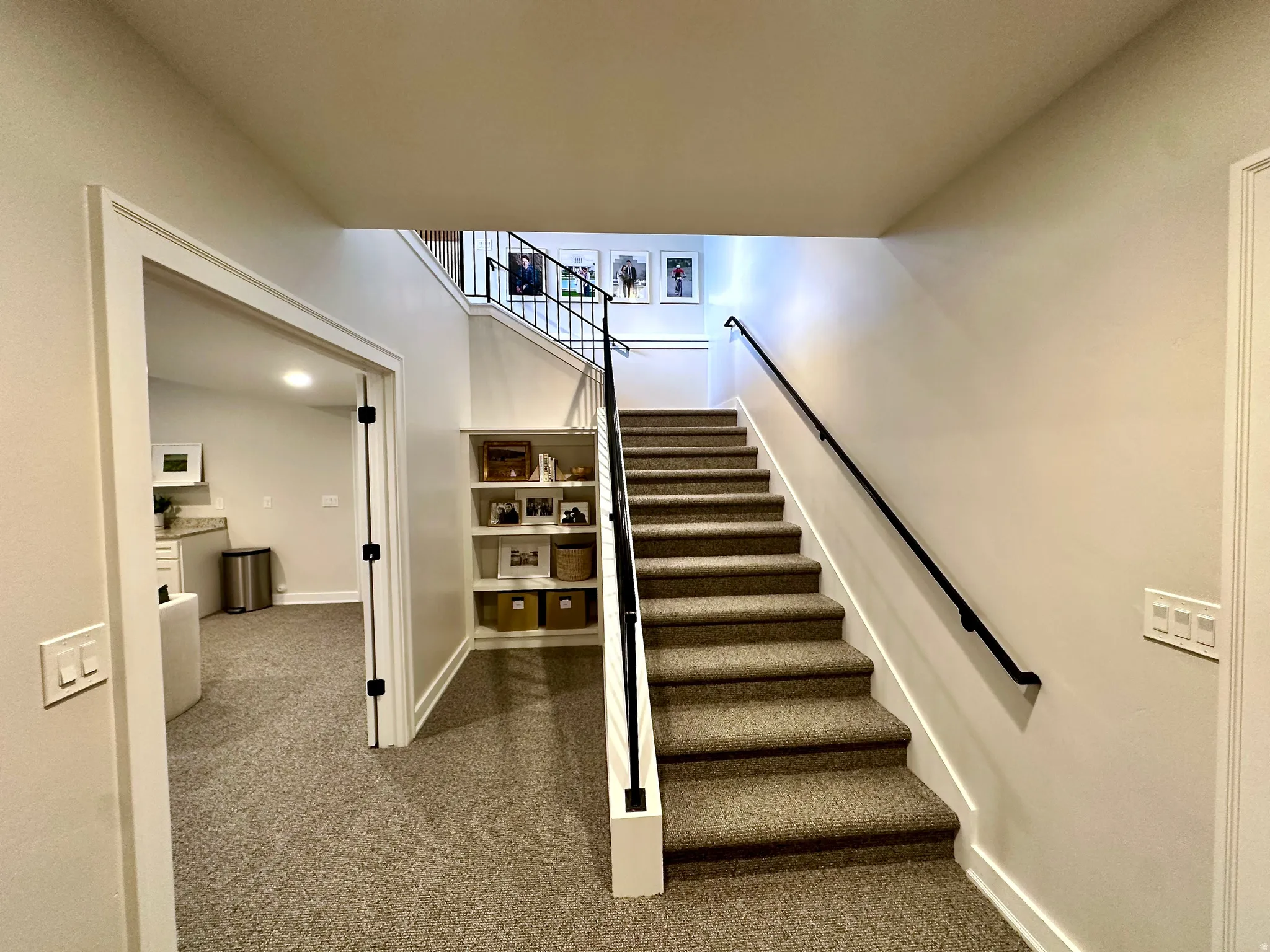 Staircase with carpet flooring and baseboards