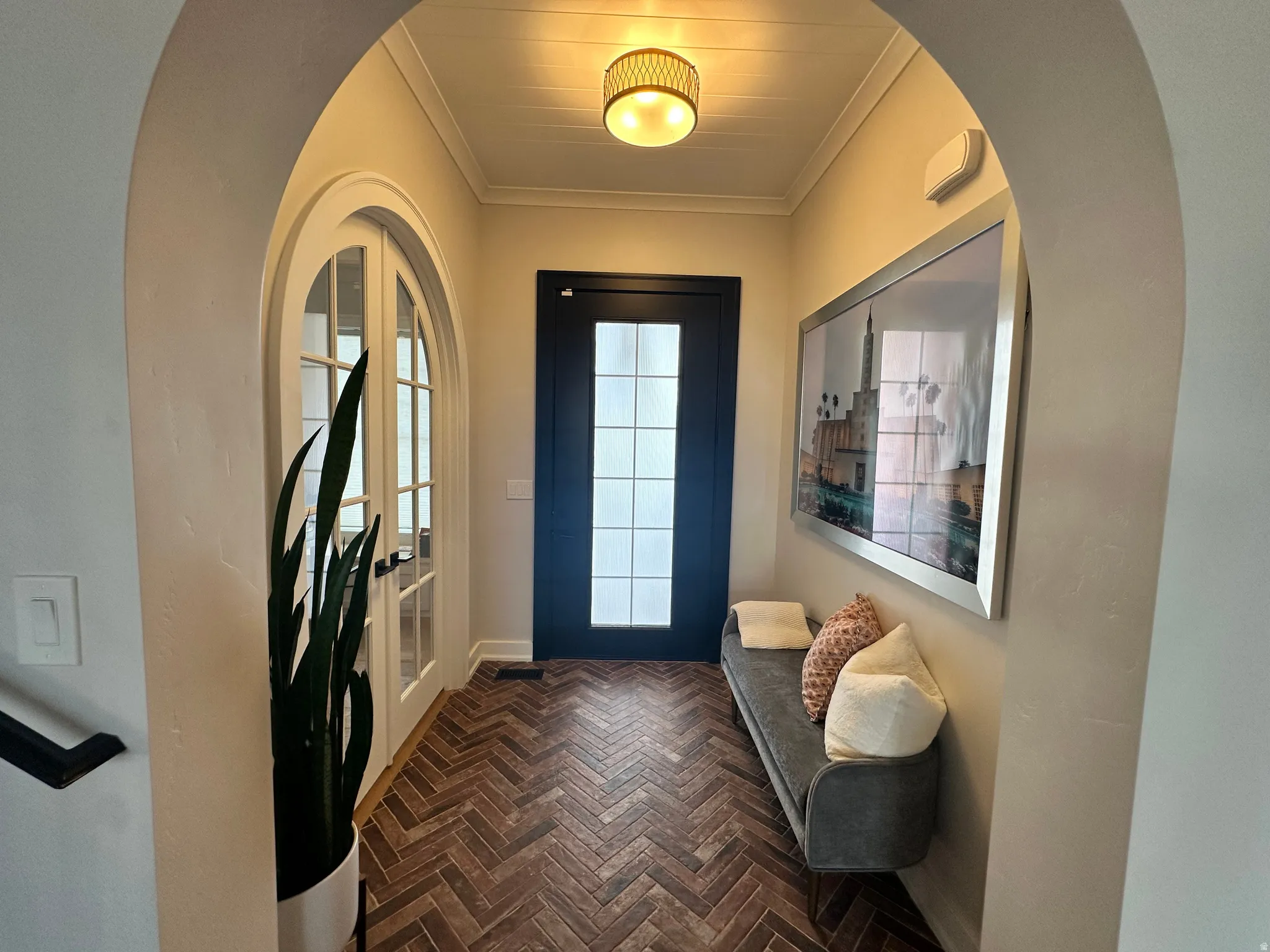 Foyer featuring ornamental molding and french doors