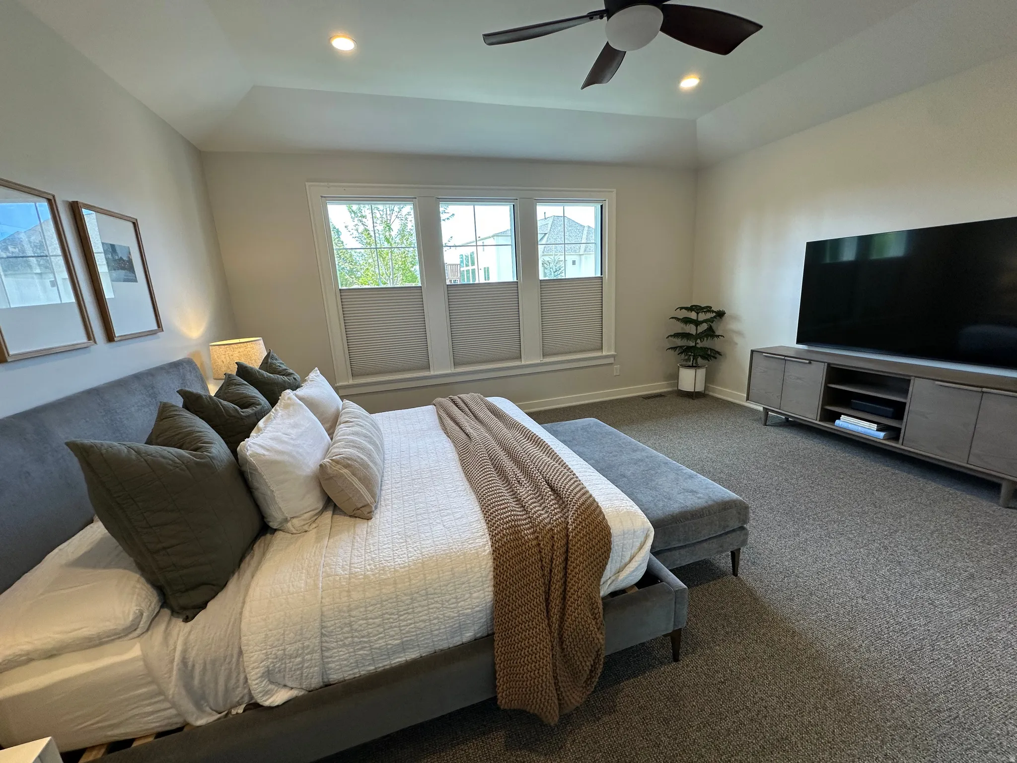 Master Bedroom with dark carpet, ceiling fan, recessed lighting, and lofted ceiling