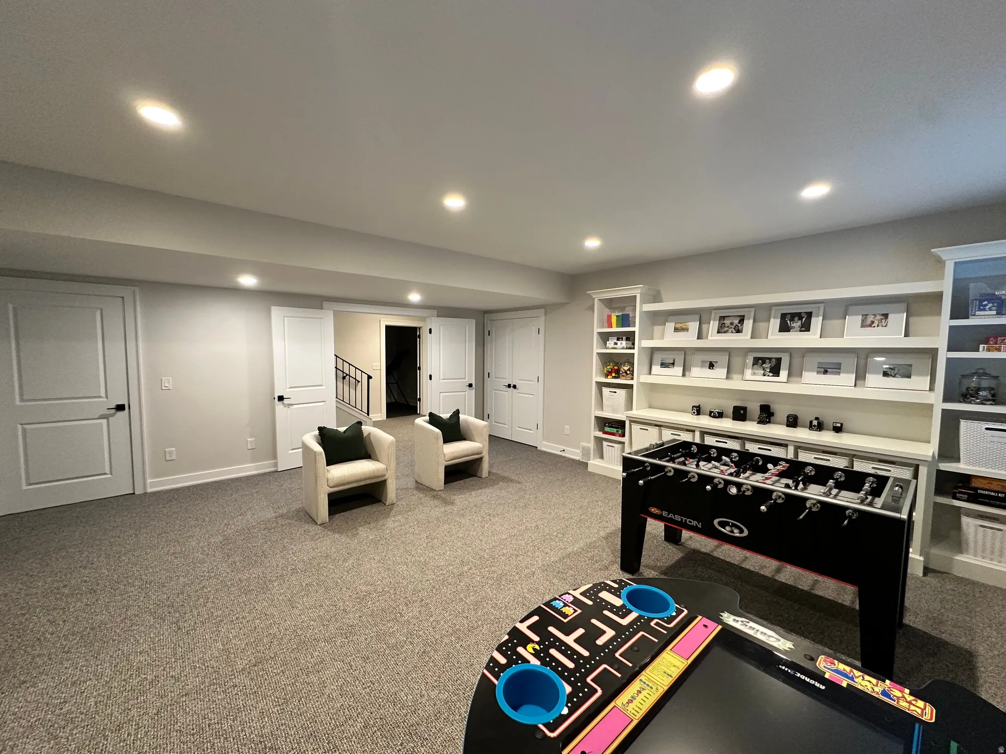 Recreation room featuring light carpet and recessed lighting