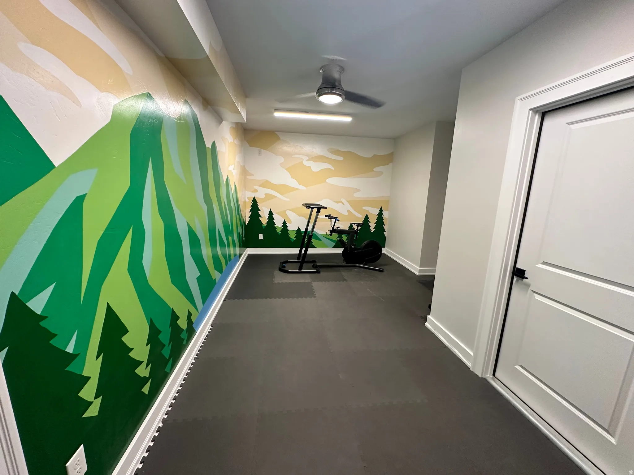 Corridor with baseboards and an accent wall