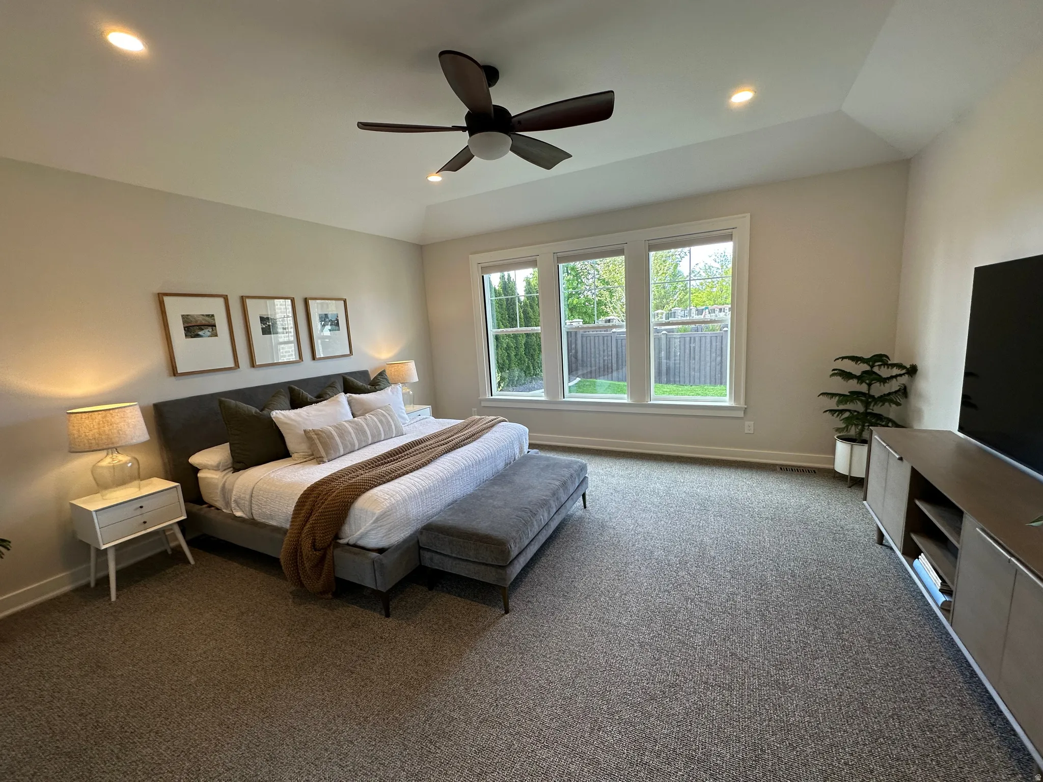 Master Carpeted bedroom with ceiling fan and recessed lighting
