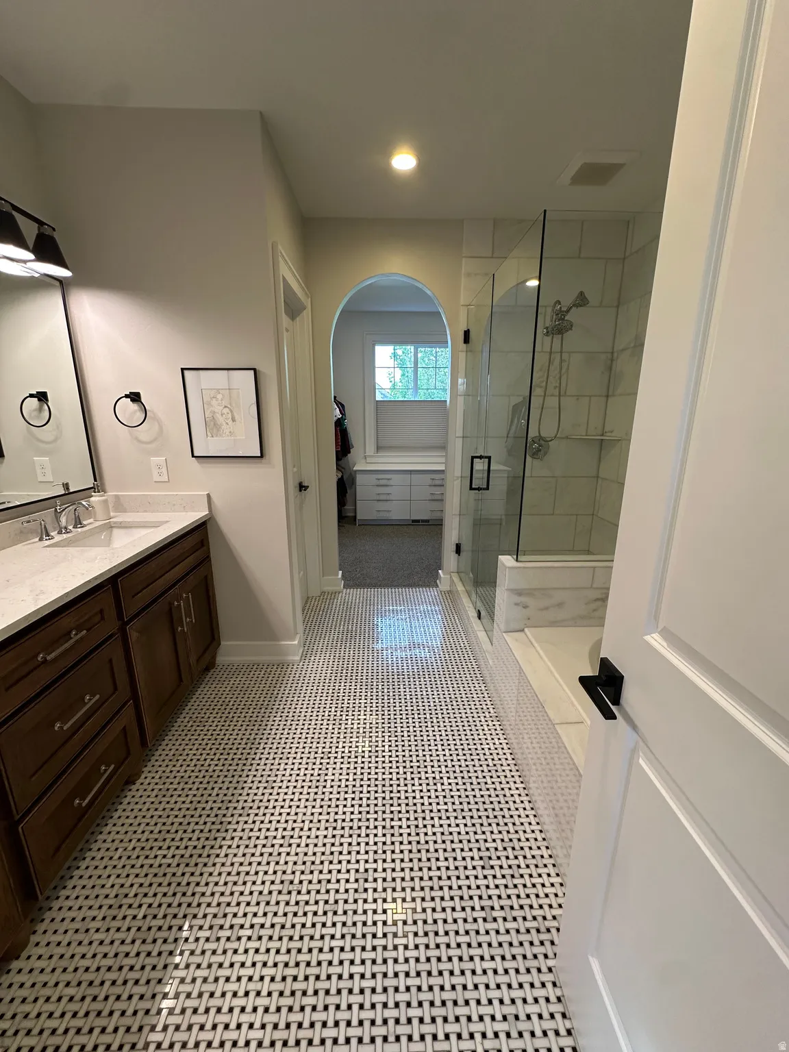 Master bath with vanity and a shower stall