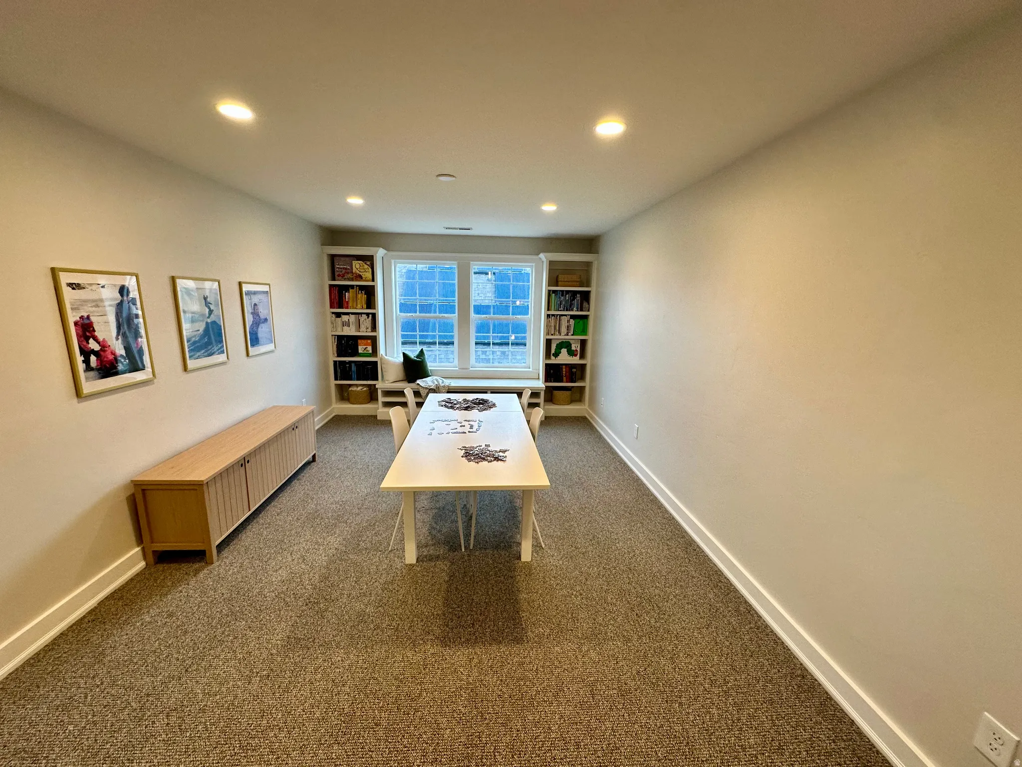 Bonus room with recessed lighting, dark carpet, and built in shelves