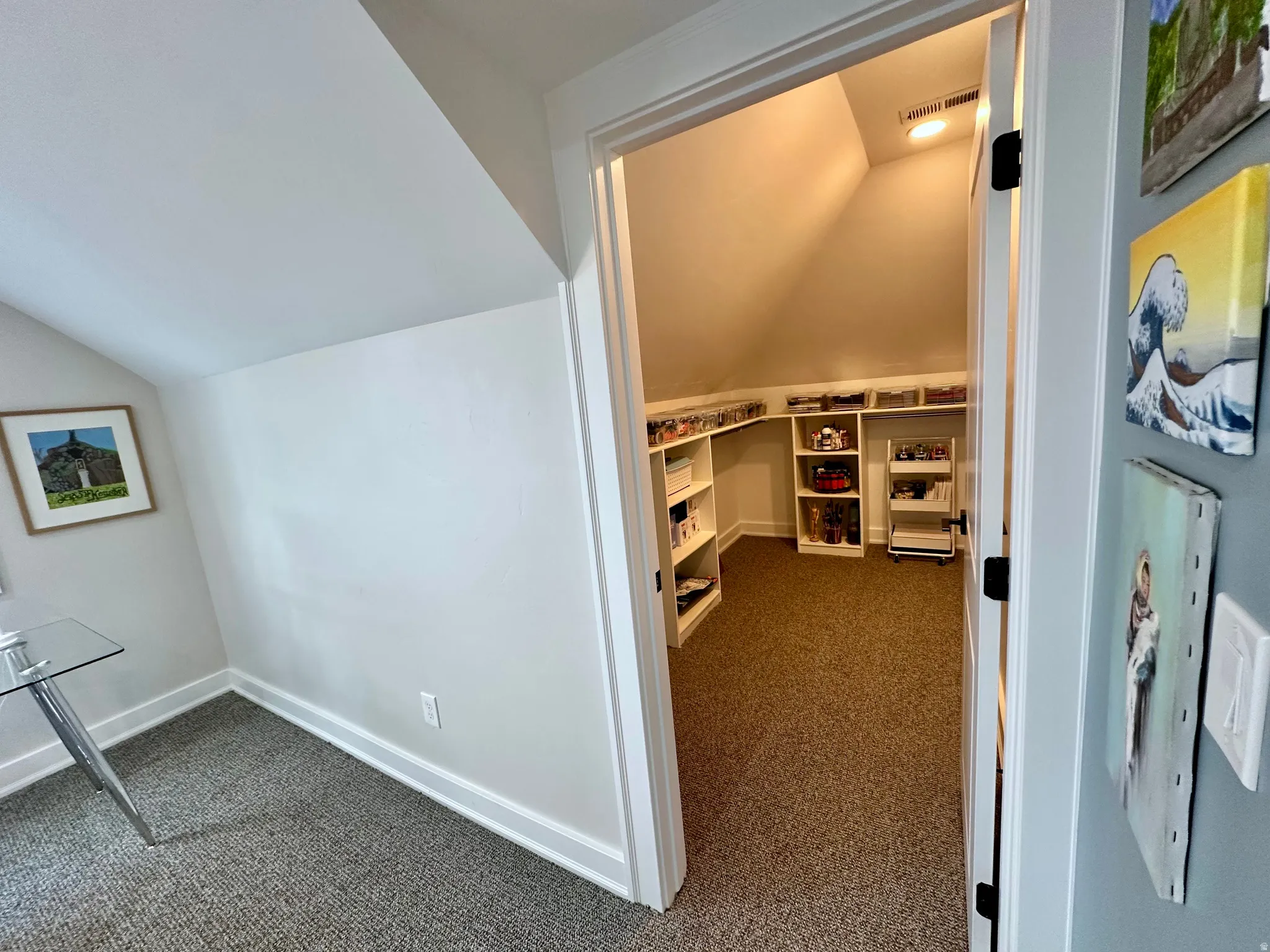 Interior space featuring lofted ceiling and dark carpet