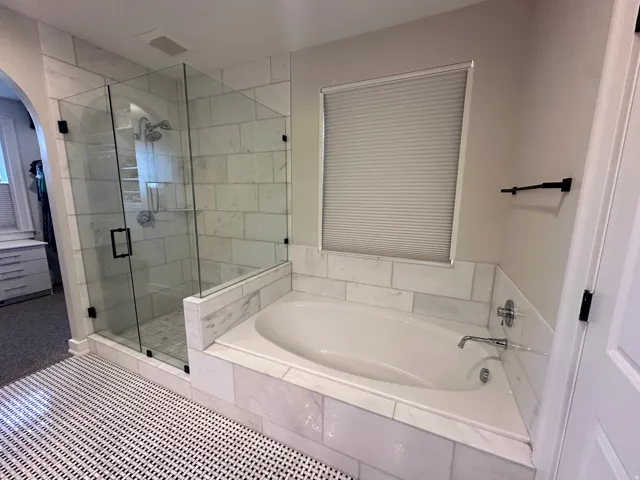 Master Bathroom with a stall shower and a bath