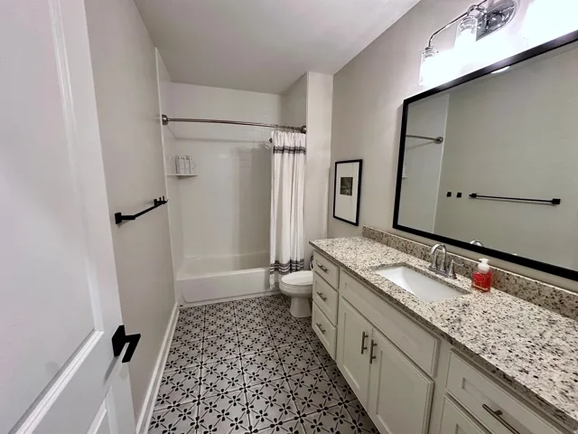 Full bath with vanity and shower / bath combo
