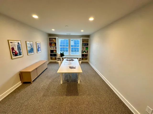 Bonus room with recessed lighting, dark carpet, and built in shelves