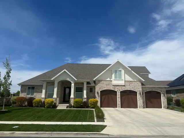 Craftsman inspired home with concrete driveway, roof with shingles, a front yard, and a porch