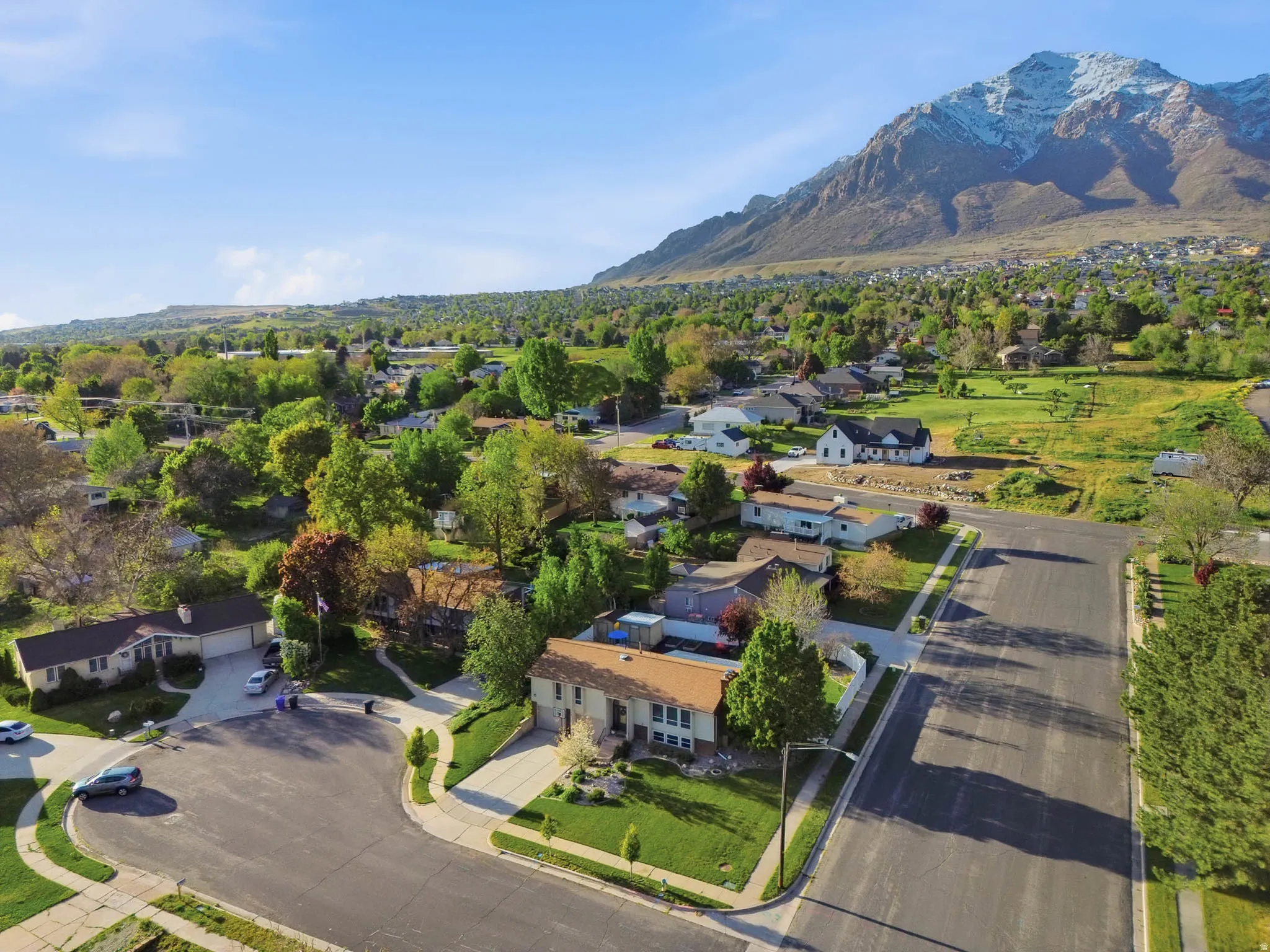 Aerial perspective of suburban area with a mountain backdrop