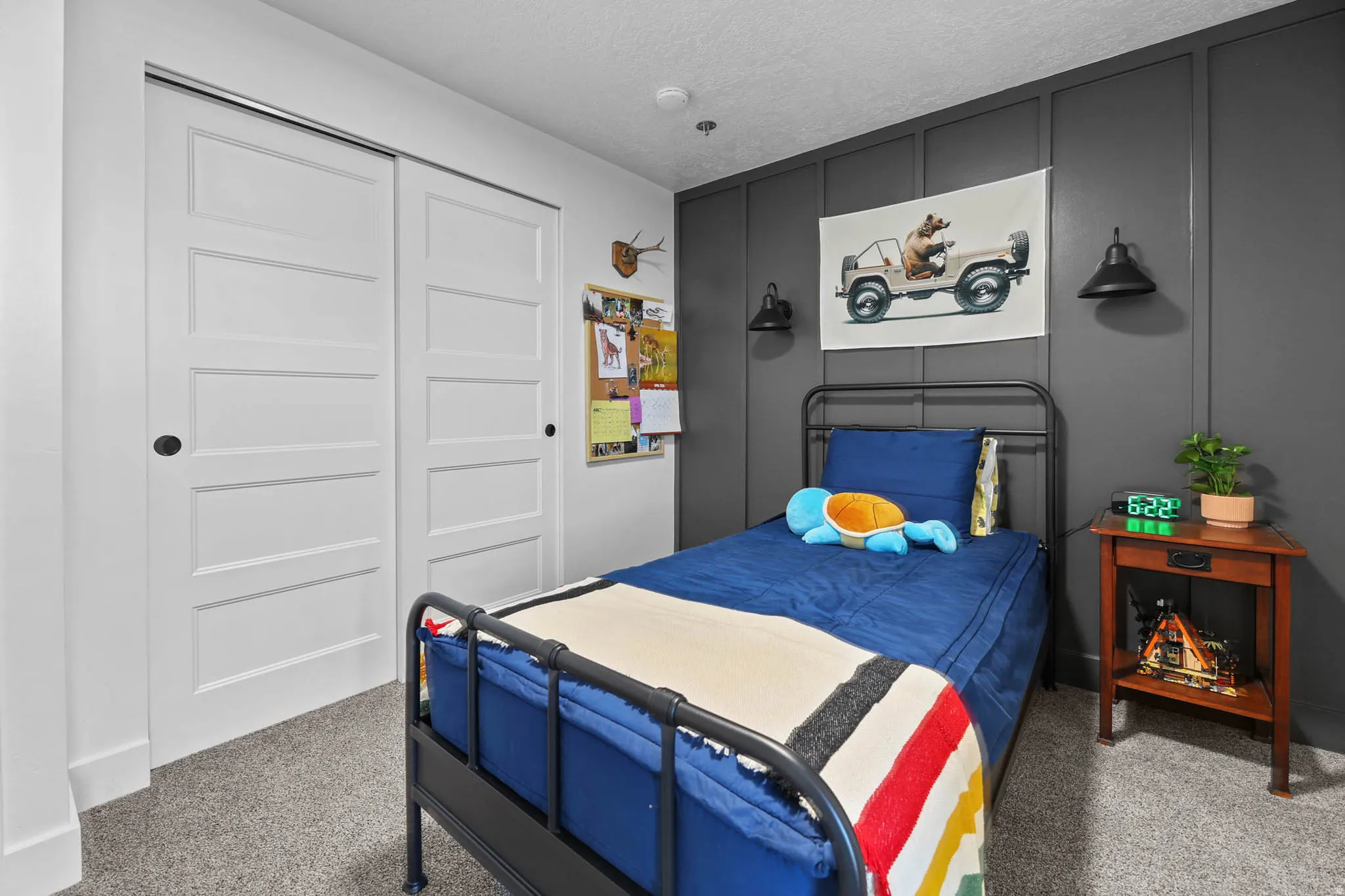 Bedroom featuring carpet flooring, a closet, and a textured ceiling