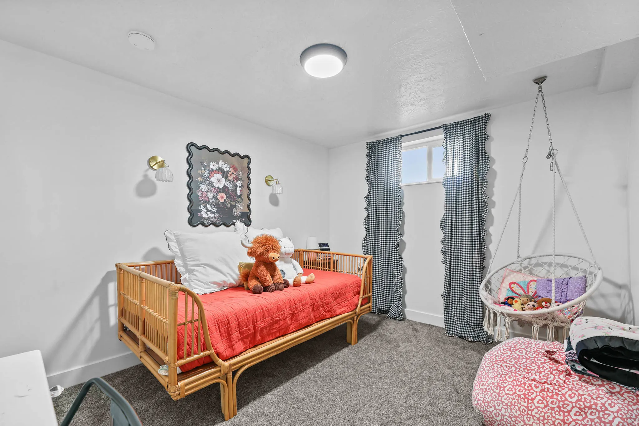 Bedroom featuring carpet and baseboards