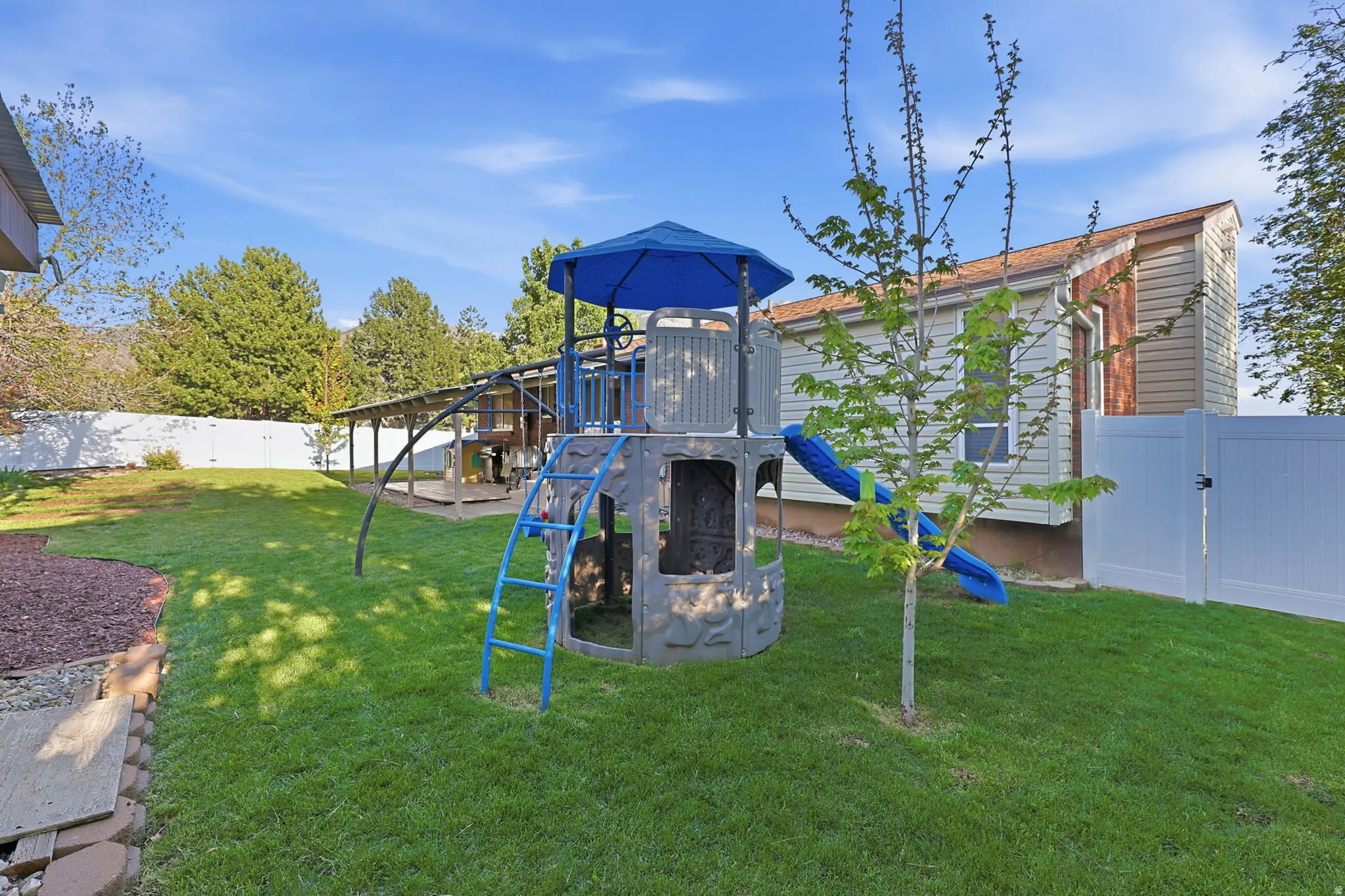 View of jungle gym featuring a fenced backyard