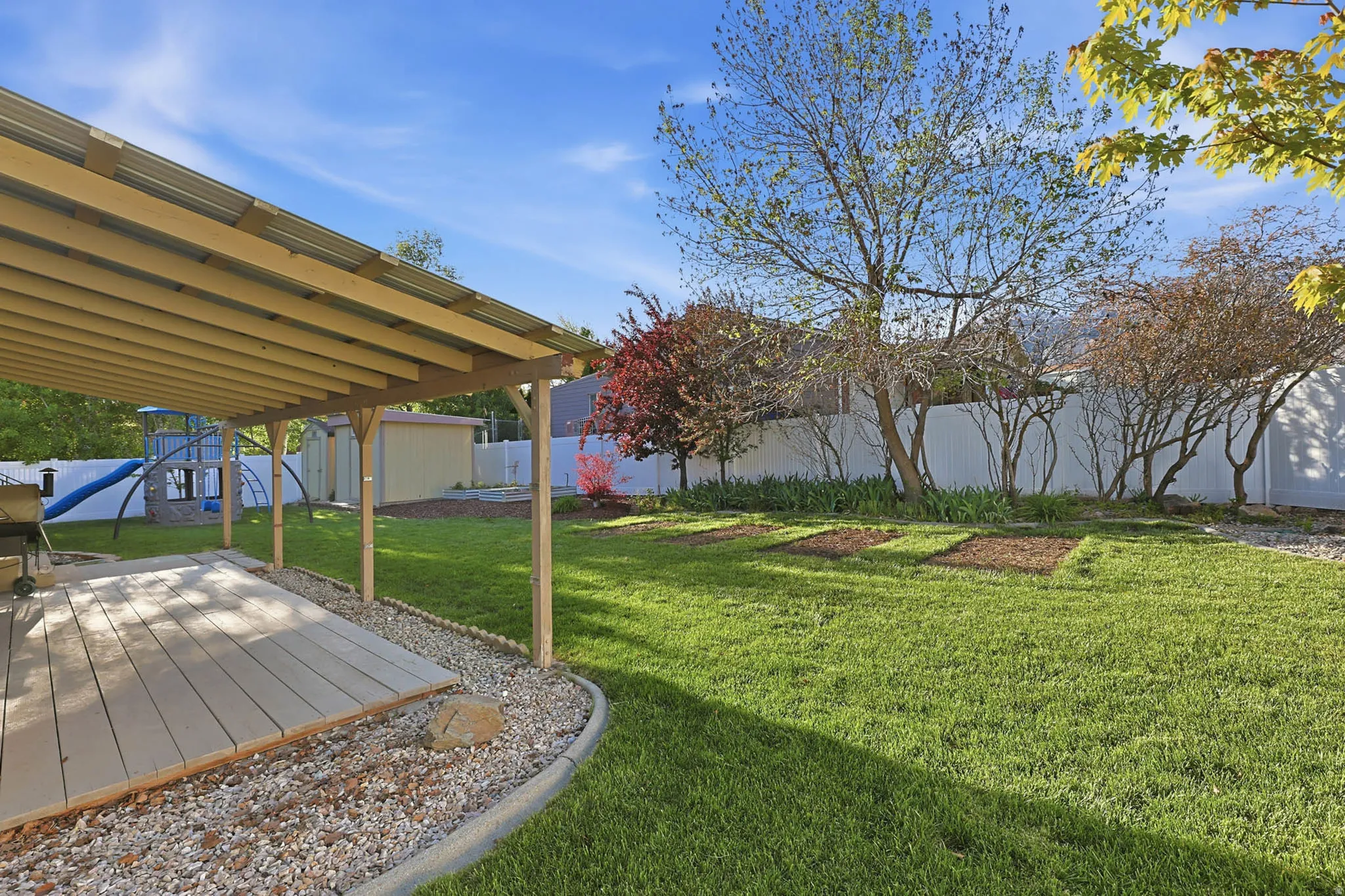 Fenced backyard with a storage unit