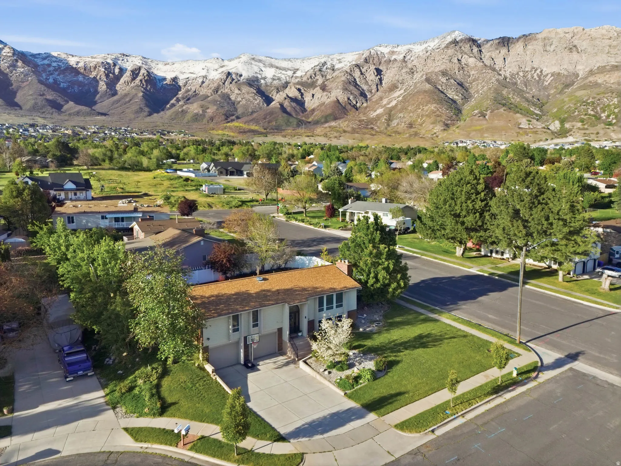 Aerial perspective of suburban area featuring a mountain backdrop