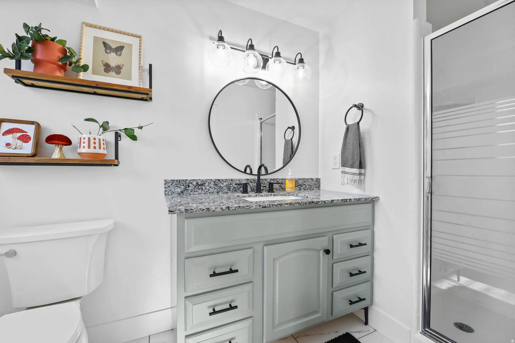 Full bathroom featuring a stall shower and vanity