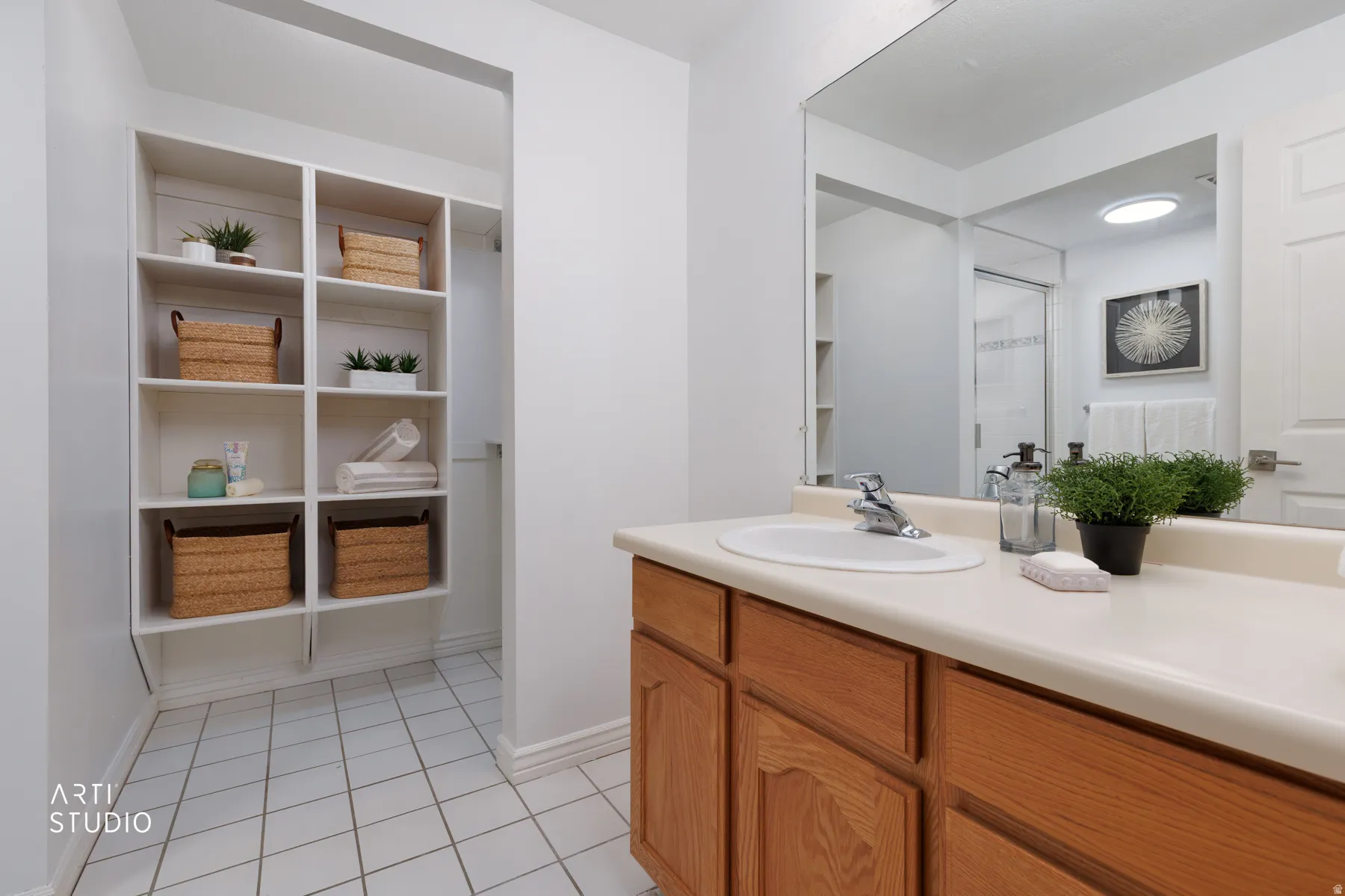 Full bathroom with vanity, light tile patterned floors, and a closet