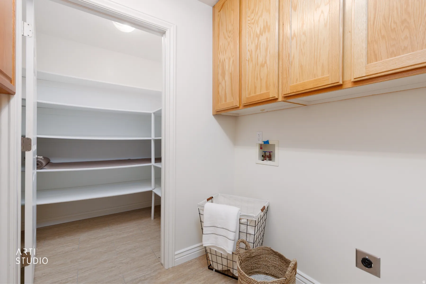 Laundry area featuring cabinet space, washer hookup, hookup for an electric dryer, and light wood finished floors