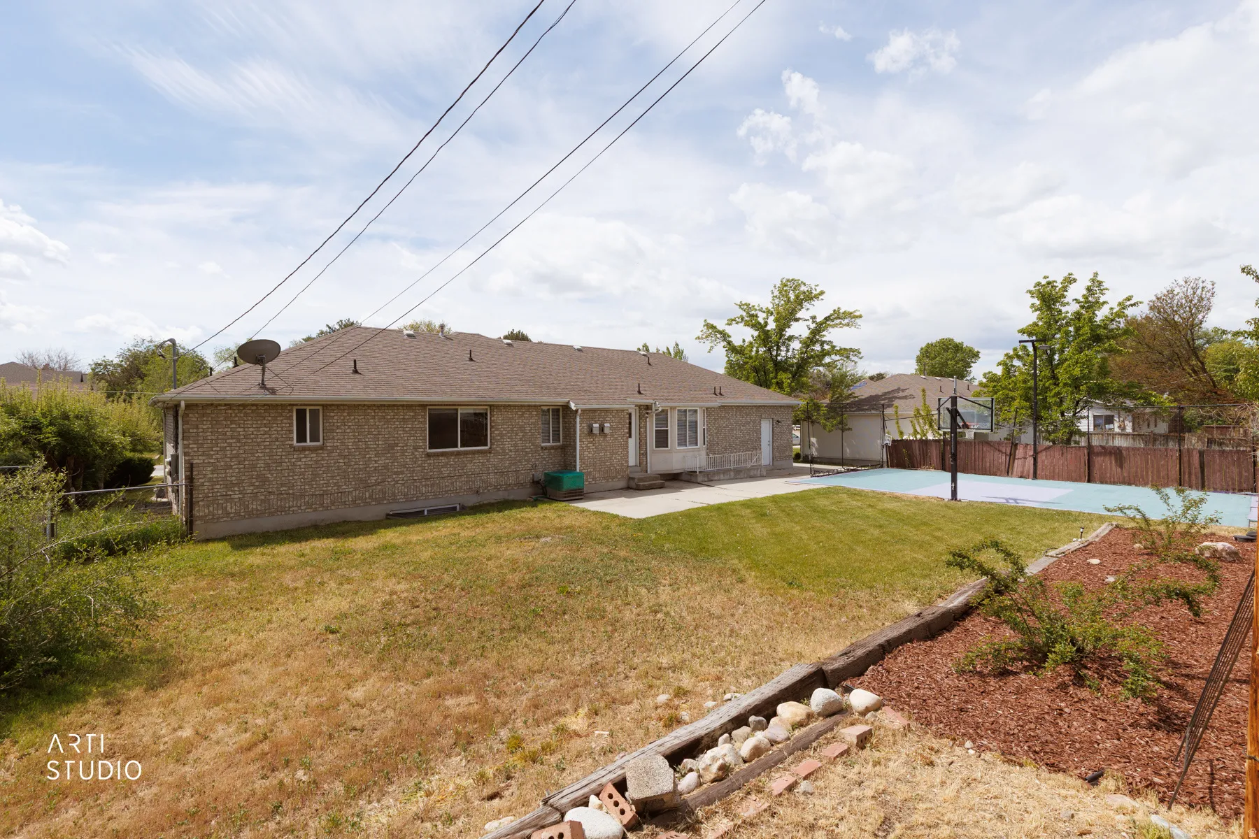 Rear view of property featuring a fenced backyard, a patio, and brick siding