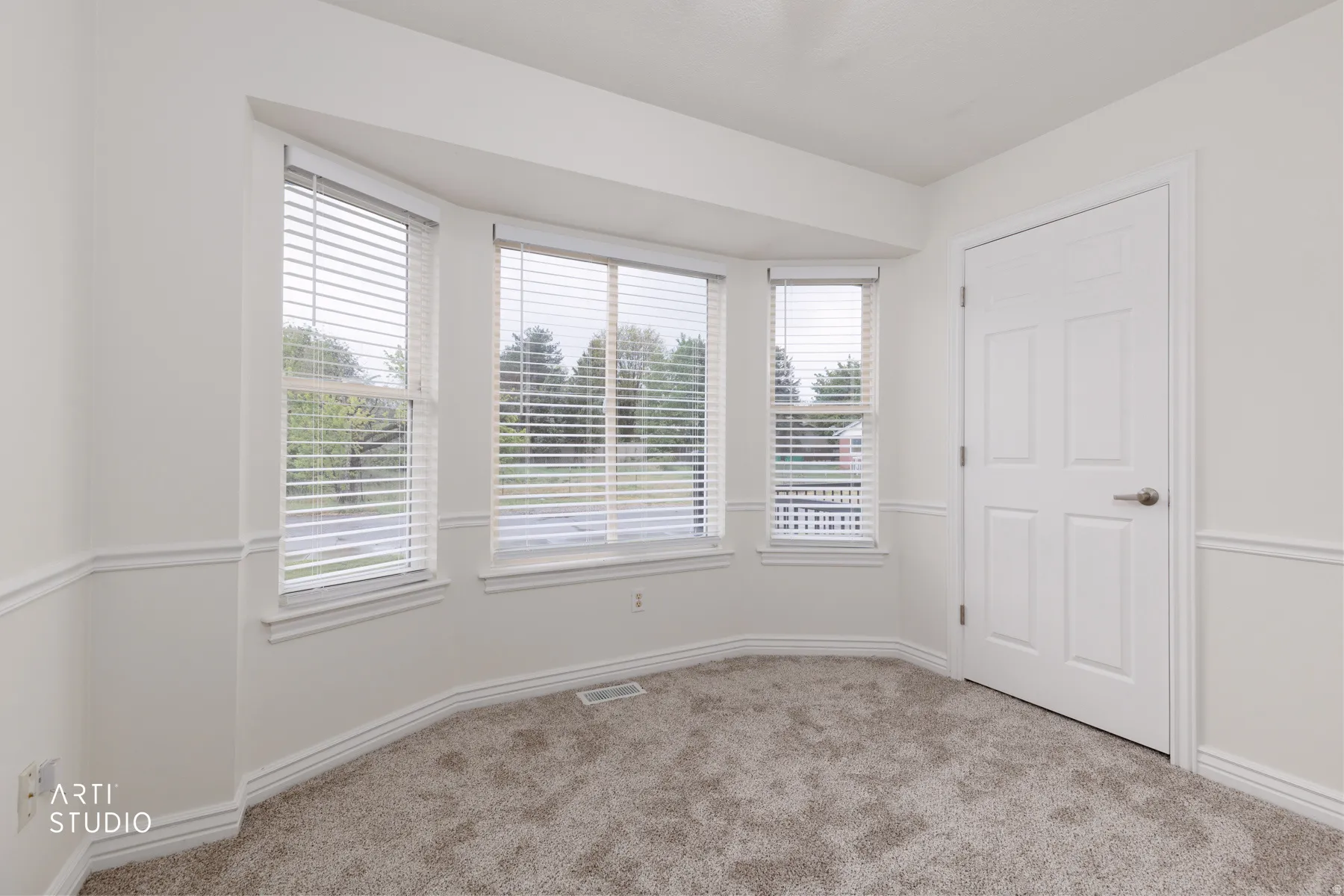 Spare room featuring carpet flooring and baseboards