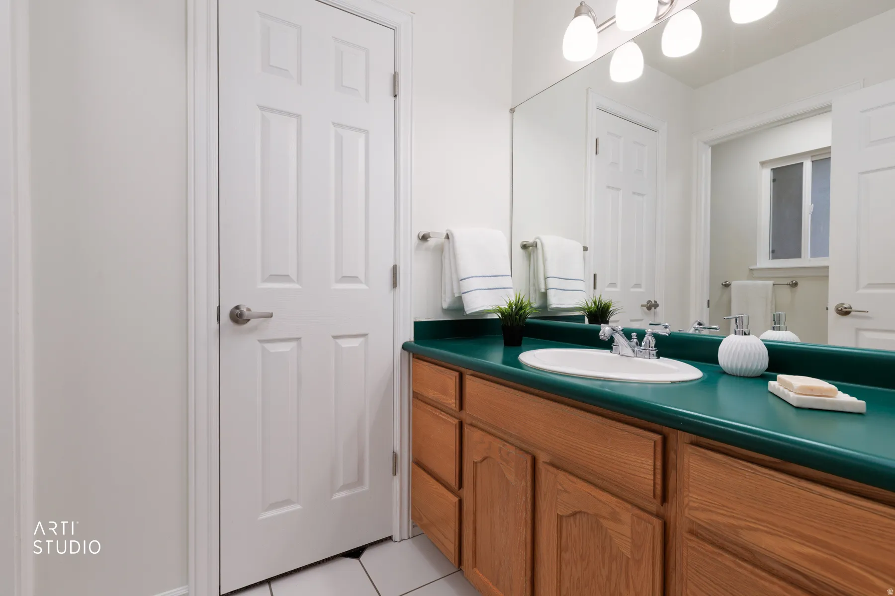 Bathroom with vanity and light tile patterned floors